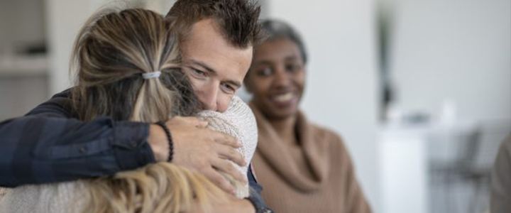 Woman and man embracing gratefully