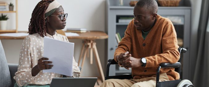 Man in wheelchair talking to a counselor